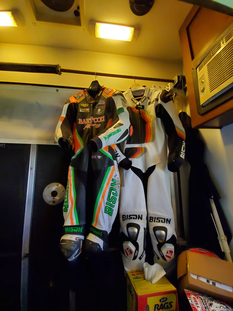 Motorcycle racing suits hanging in our RV